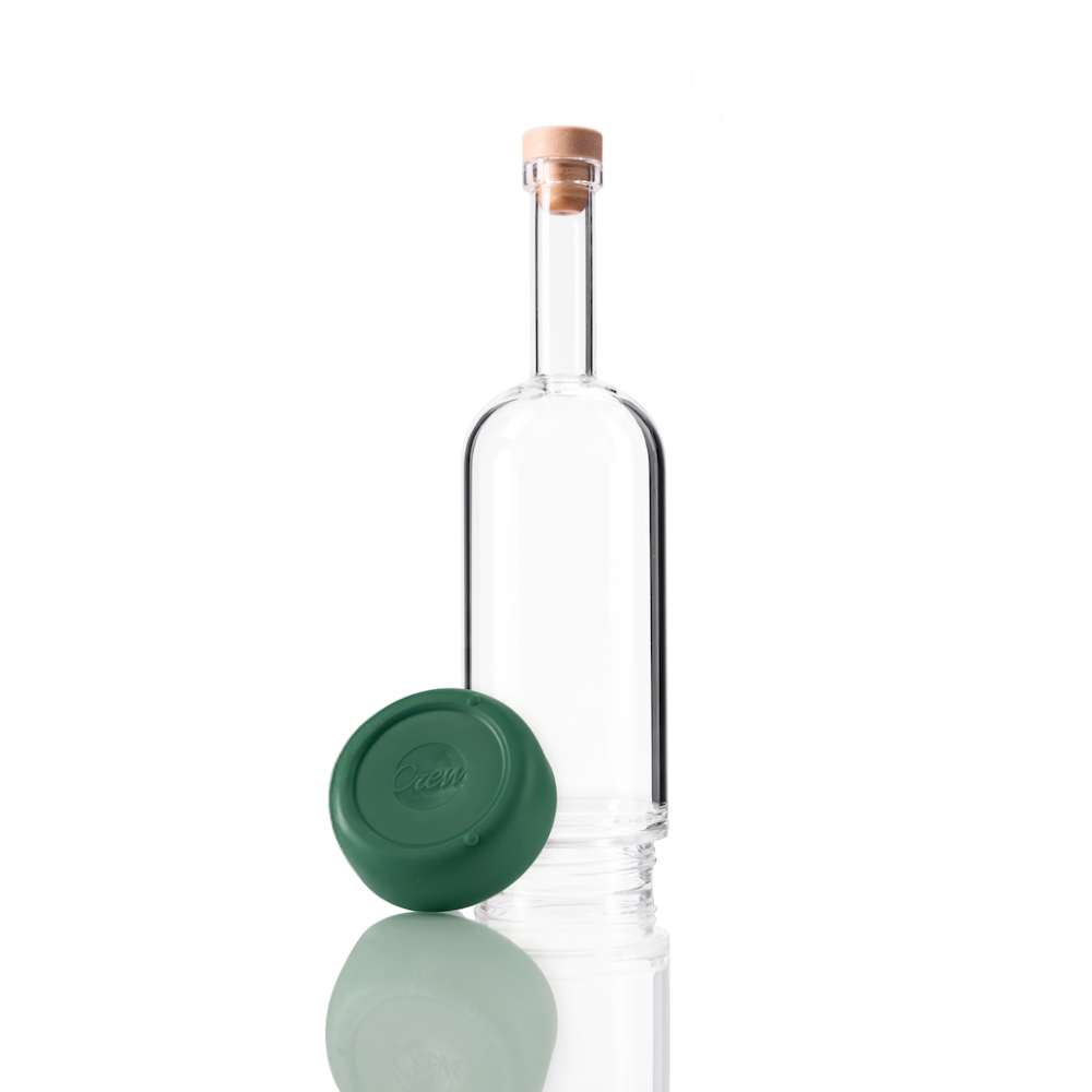 Clear glass Crew Bottle with a removable base Basil green color on white background