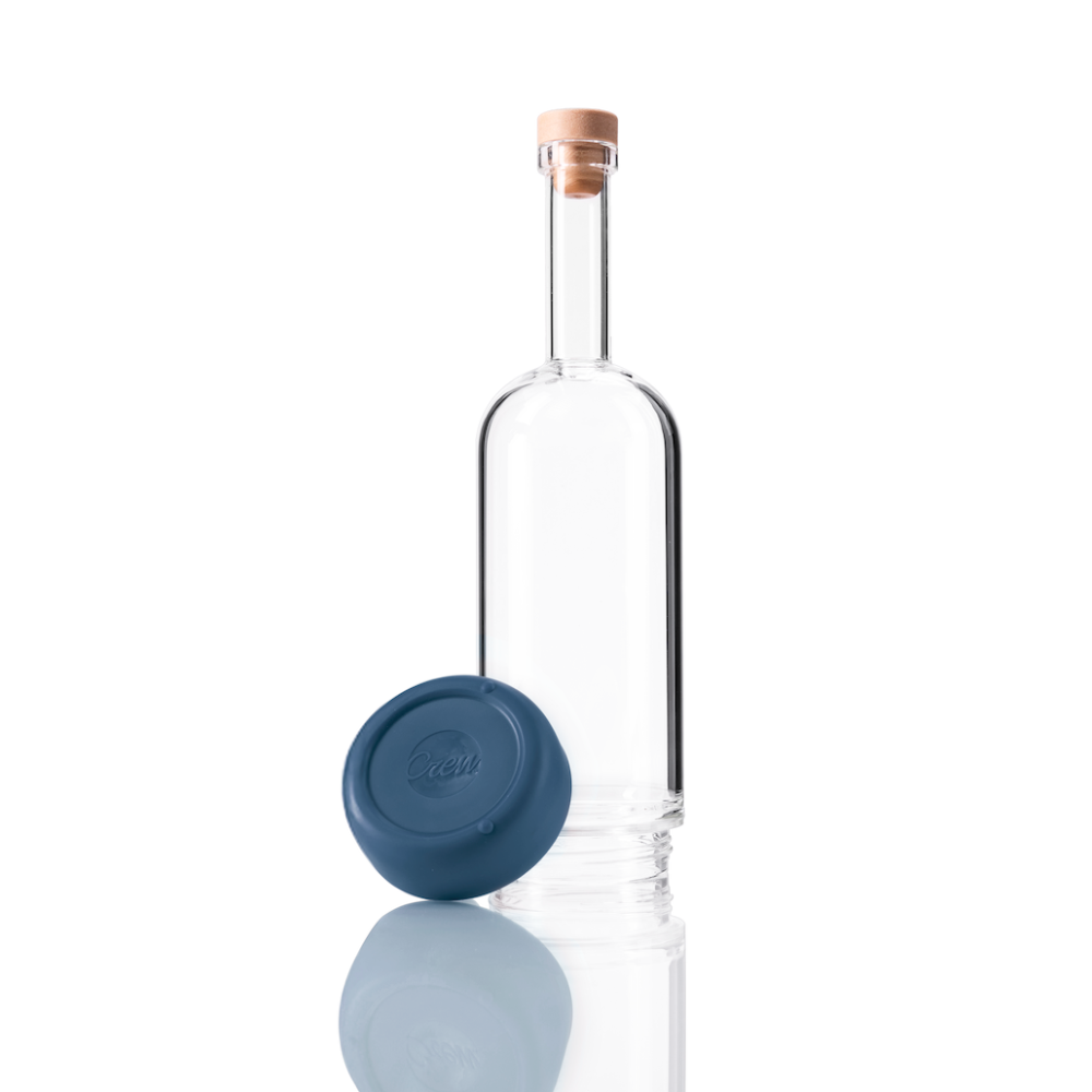 Clear glass Crew Bottle with a removable base Crew Blue color on white background