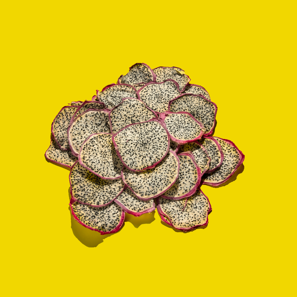 Sliced dehydrated dragonfruit garnishes on a yellow background