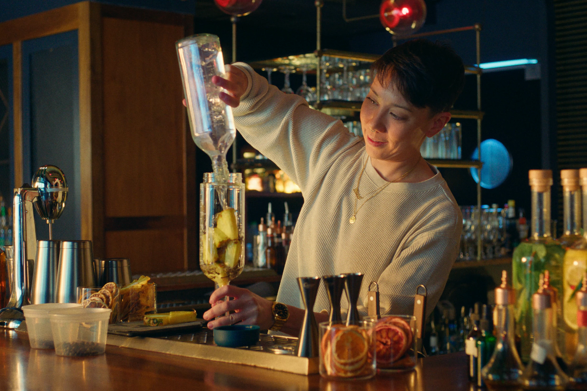 Bartender batching cocktail into a Crew Bottle