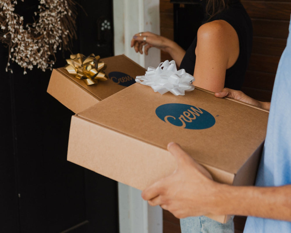 People bringing Crew cocktail kit and gift sets to a home