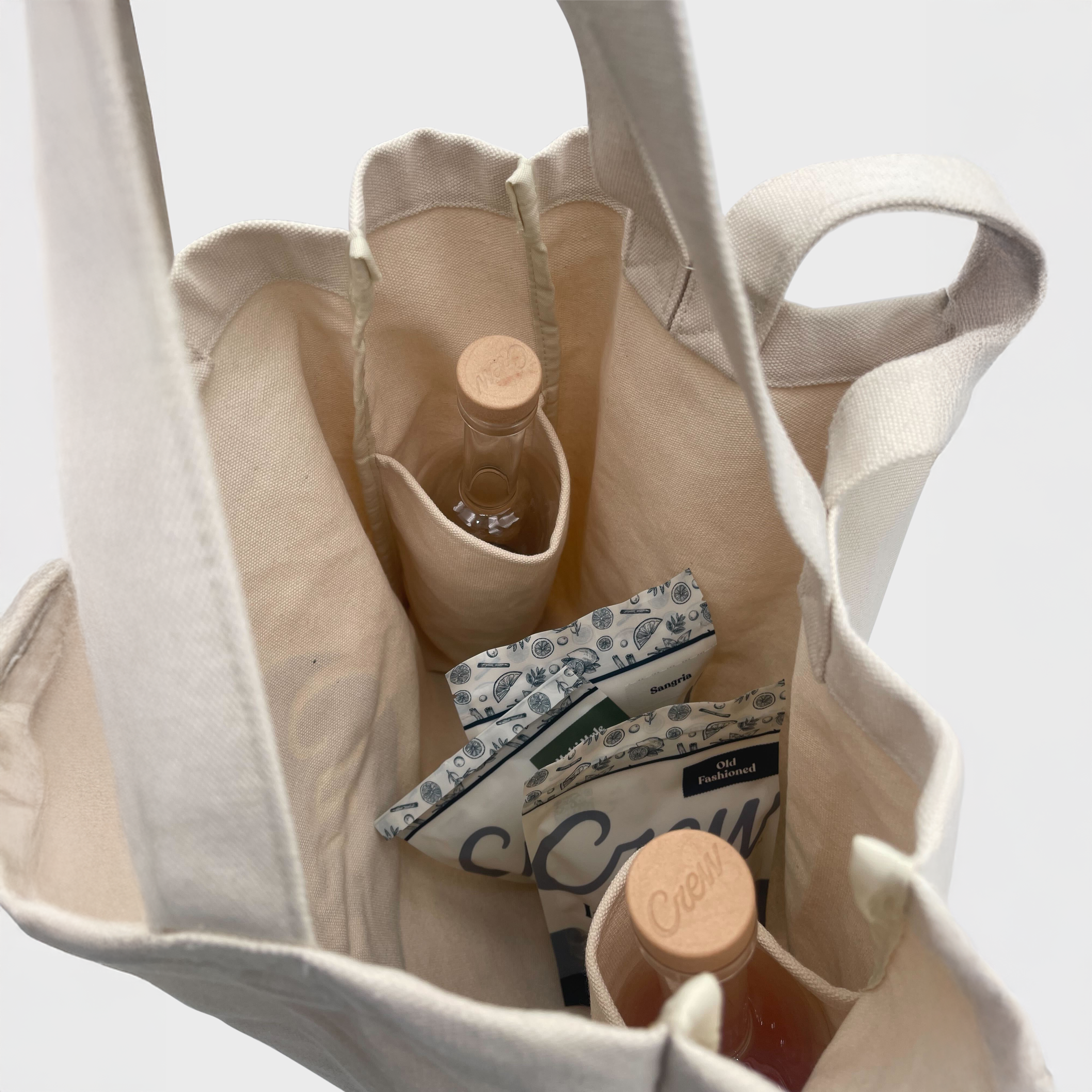 Canvas tote bag with Crew bottles and a infusion mixes inside