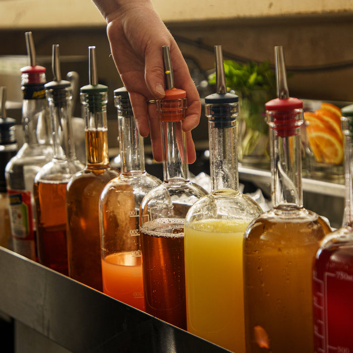 A picture of bar supplies including crew bottles and pour spouts