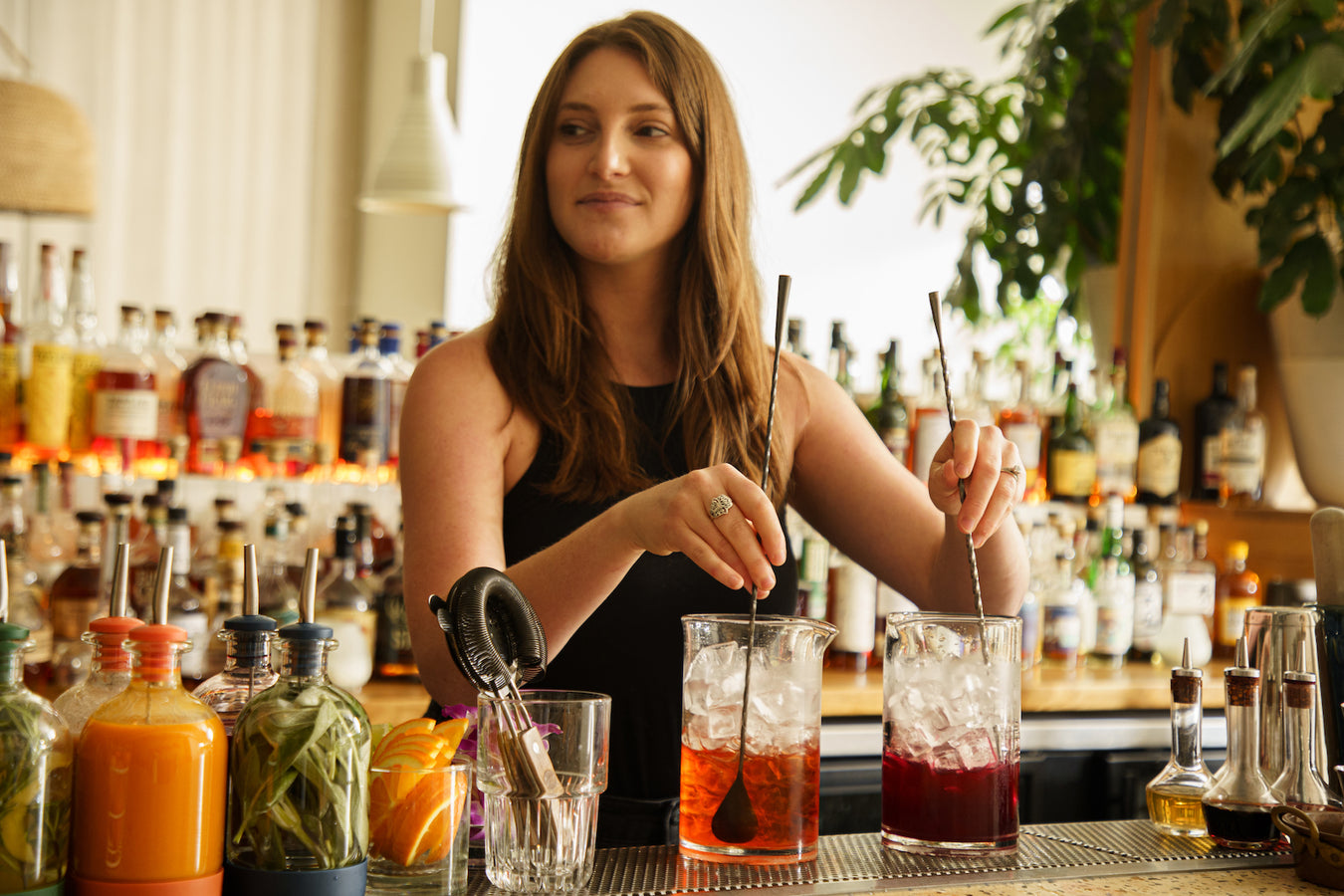 Bartender using stylish bar supplies to stir cocktails confidently 