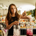bartender pouring infusion from pour spout into bar jigger