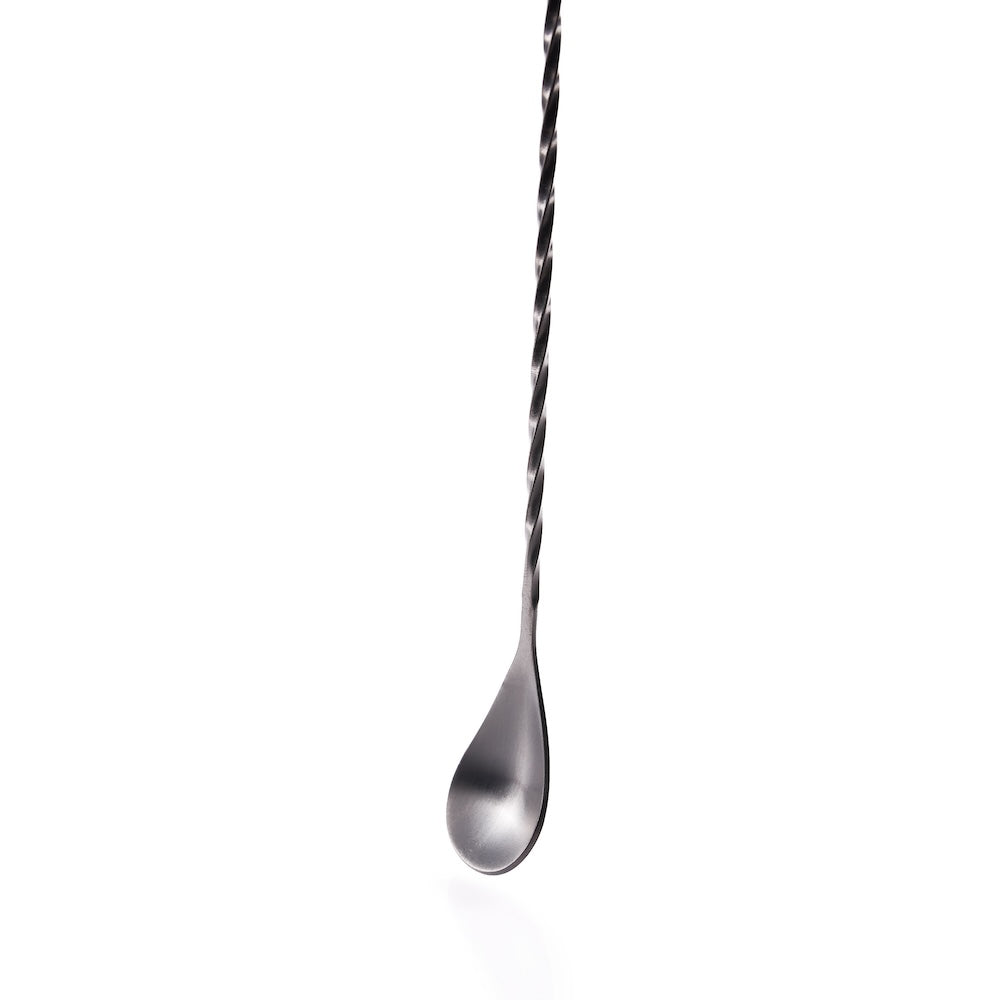 Close up of a cocktail bar spoon with twisted handle on a white background