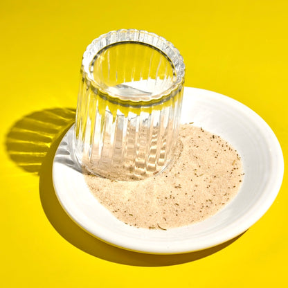 Glass leaning into bloody mary cocktail rimming salt