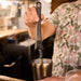 Bartender muddling ingredients for a cocktail