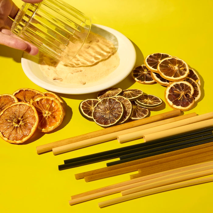 A garnish station sample kit including dehydrated orange slices, dehydrated lemon wheels, dehydrated lime wheels,  spicy margarita rimming salt, and plant-based agave straws