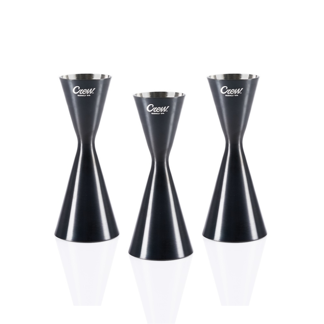 Three cocktail jiggers for bartenders on a white background