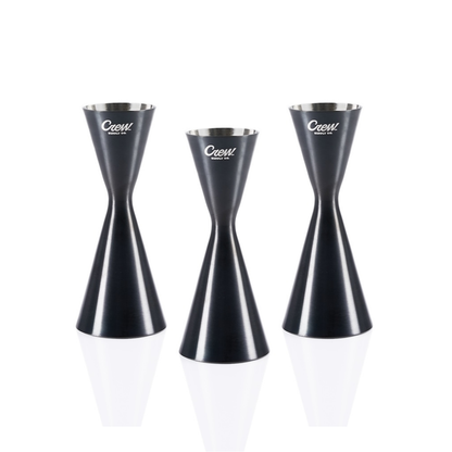 Three cocktail jiggers for bartenders on a white background