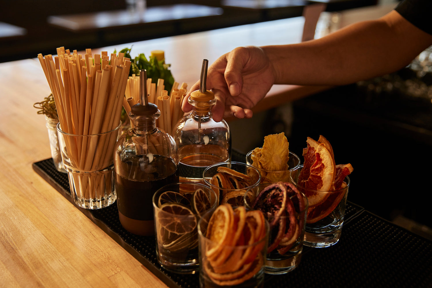 Cocktail prep station with bar supplies and dried garnishes