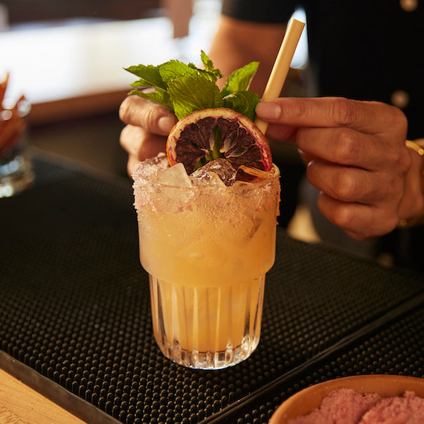 craft cocktail garnishes with blood orange straw mint and hibiscus rimming salt sugar