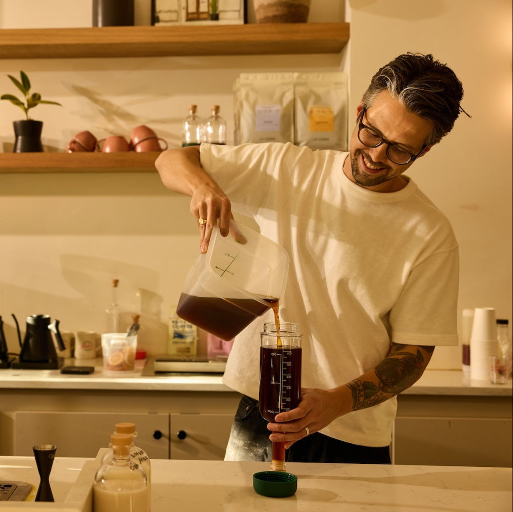 Barista using Crew Bottle for pre-batching coffee syrups