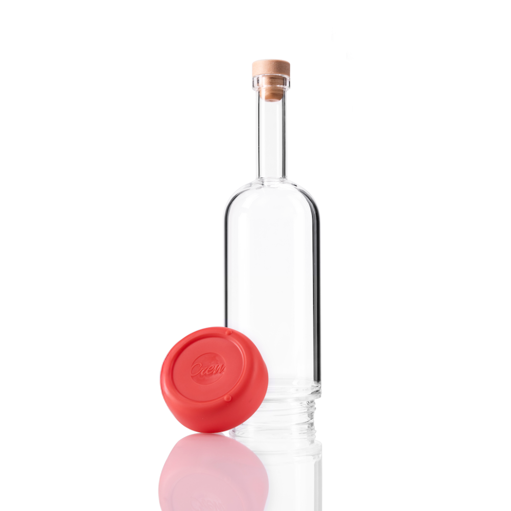 Clear glass Crew Bottle with a removable base Ruby color on white background