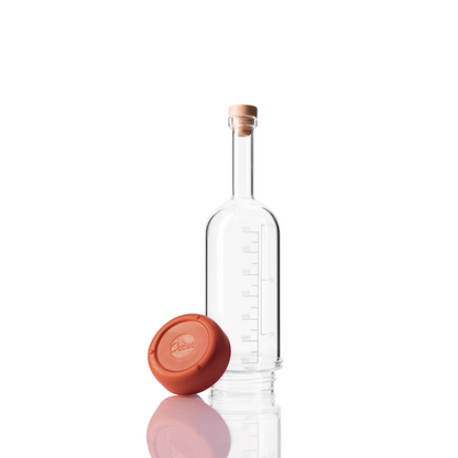 Glass Crew Bottle with measurement lines and a removable base Burnt Orange color on white background