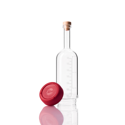 Glass Crew Bottle with measurement lines and a removable base Merlot red color on white background