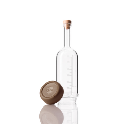 Glass Crew Bottle with measurement lines and a removable base Mocha brown color on white background