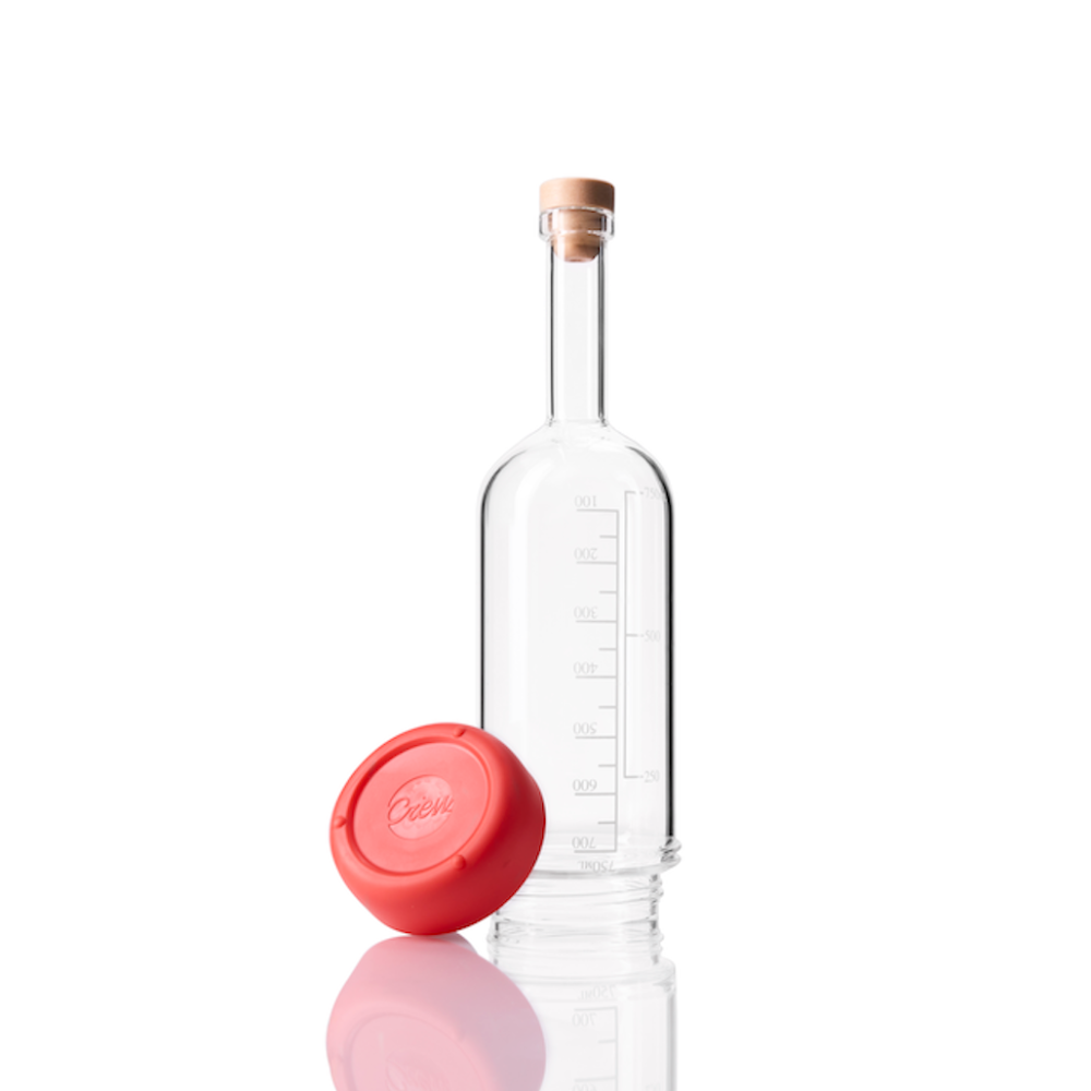 Glass Crew Bottle with measurement lines and a removable base Ruby color on white background