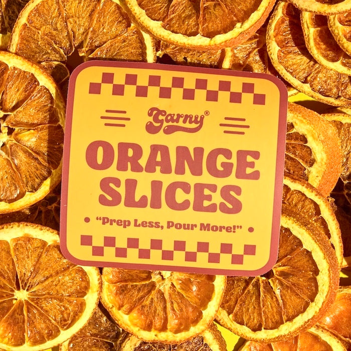 Pile of dehydrated orange slices for cocktail garnish station.