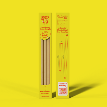 Two yellow cardboard boxes for Garny plant-based straw samples, standing upright on a bright yellow background. The left box shows several Bamboo Fiber straws and the back of the box displays printed product information and a QR code.