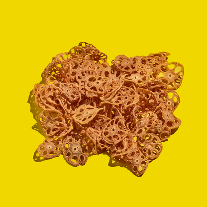 Dehydrated lotus root slices on a yellow background
