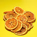 Pile of dehydrated orange slices for cocktail garnish station.