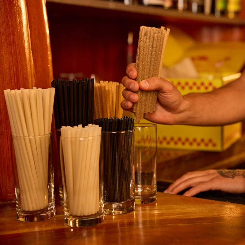 Bartender stocking agave straws on the bartop