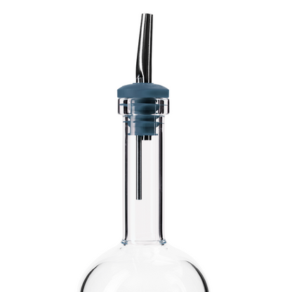 Glass batch bottle with blue pour spout on a white background