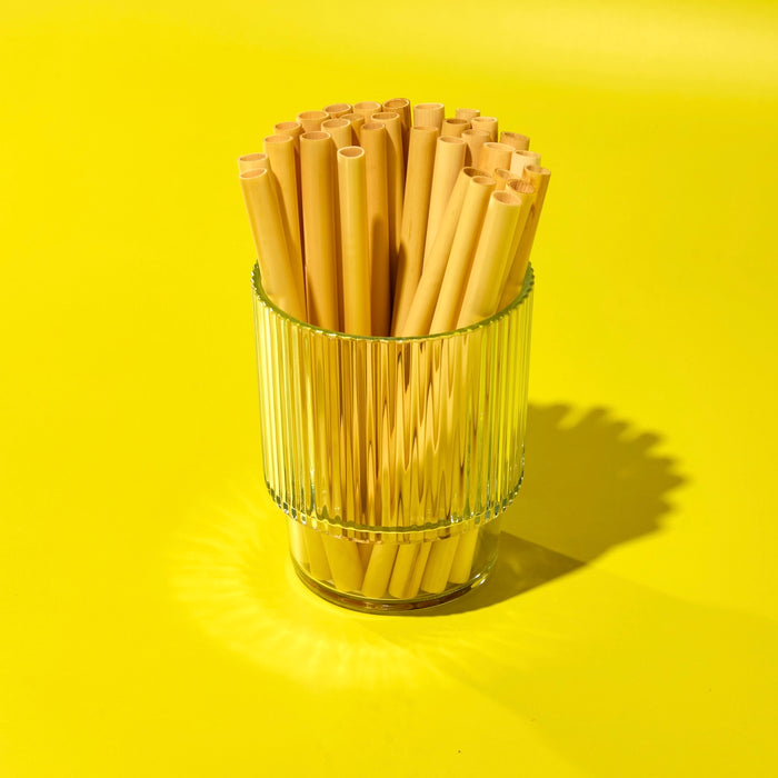 Short reed plant-based straws for cocktails stacked in a glass