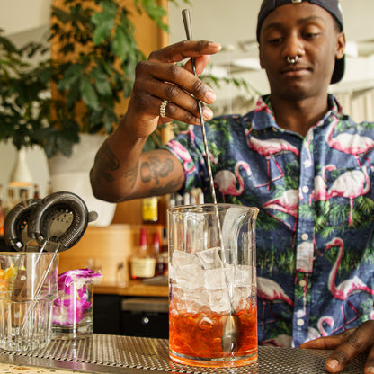 Bartender mixing negroni